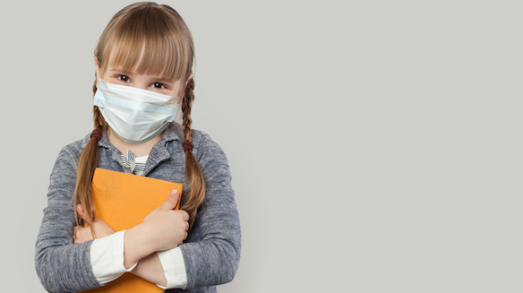 Happy child girl wearing medical protective face mask on white background